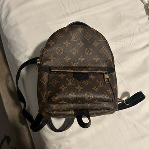 Brown monogrammed mini backpack. INSPIRED